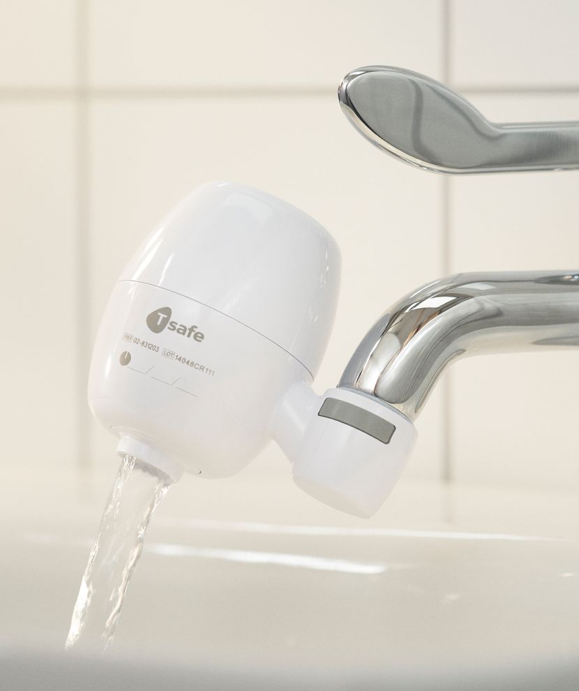A sink with the T-safe Medical Tap Filter Side Mount attached.