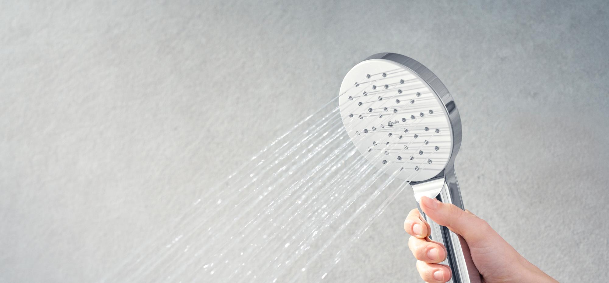 Close-up of a T-safe Aegis Hand Shower Filter being held by a hand with water flowing from it in a steady stream.