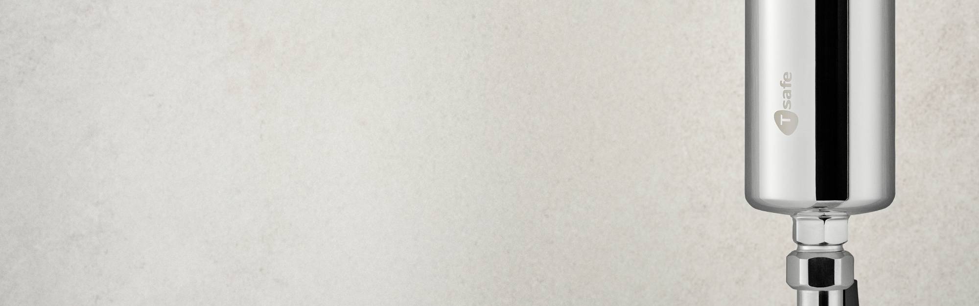 Cropped view of Chrome In-Line Filter installed vertically on a light background.