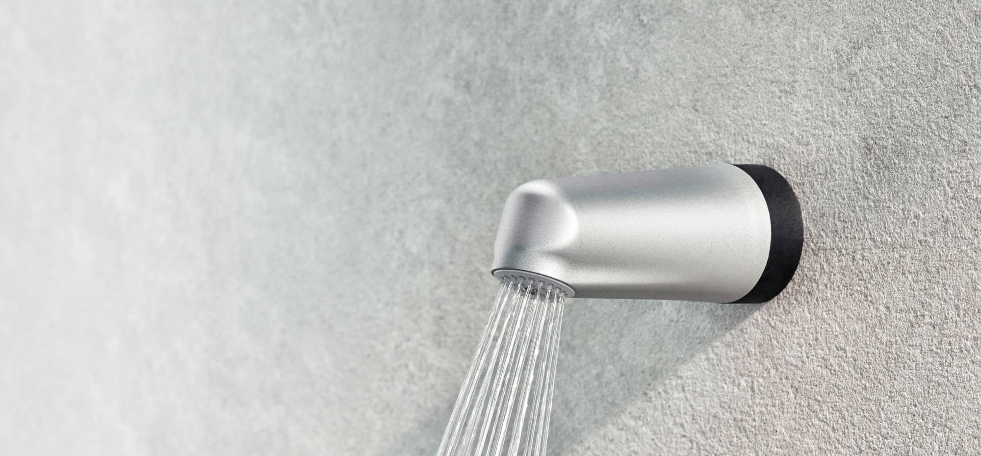 Close-up of the Flex Wall Shower Filter on a wall of grey plaster.
