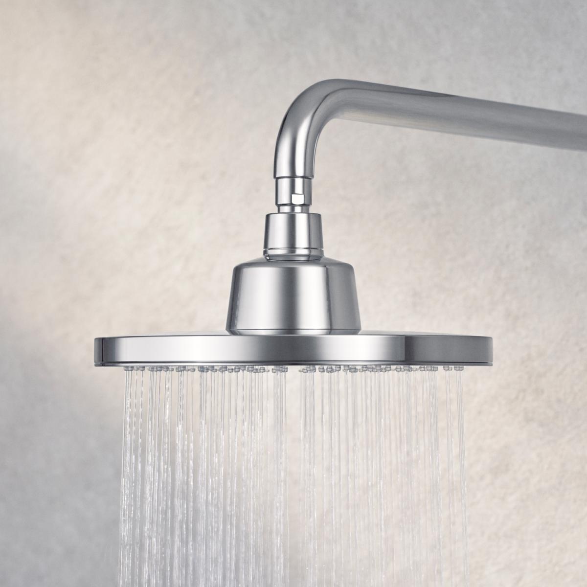 Close-up of a T-safe Aegis Overhead Shower Filter mounted on a wall with water flowing from it in a steady stream.